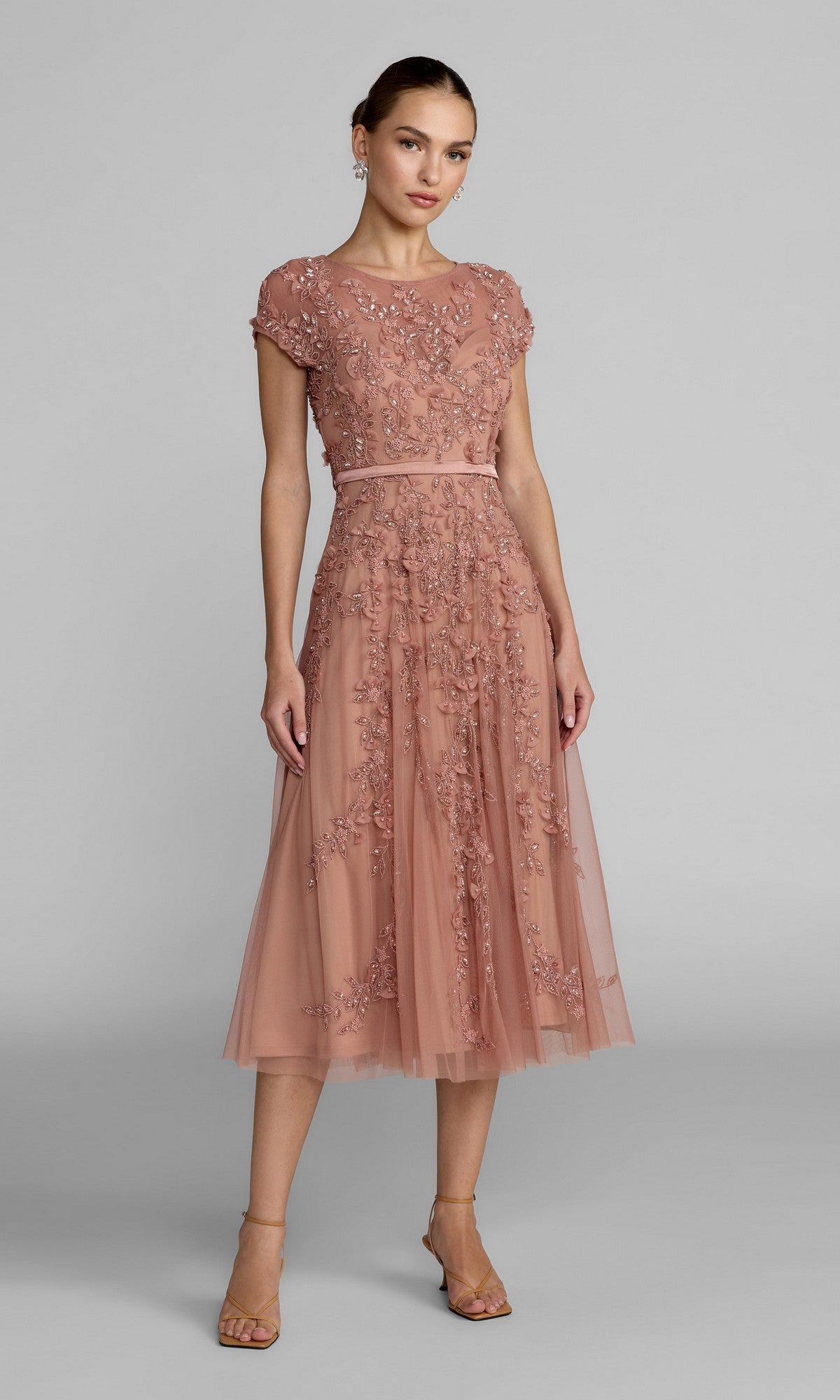 Woman wearing the Mac Duggal 94339 Midi Wedding Guest Dress in Rosewood, featuring an a-line silhouette with floral embroidery and a tulle overlay, ideal for wedding receptions, standing against a plain gray background.